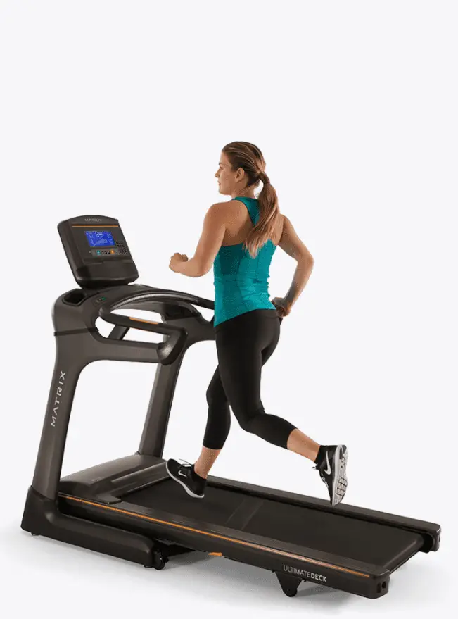 Woman wearing Blue Green top and black leggings running in a Matrix Treadmill TF30xr