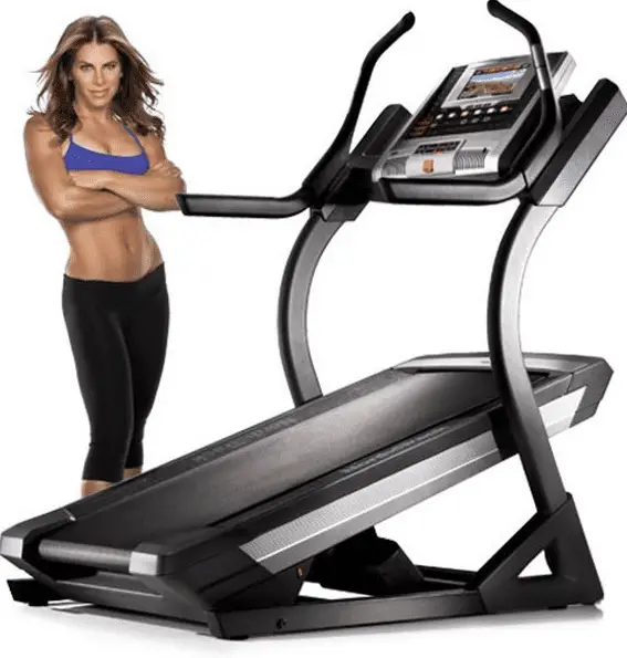 Woman in sports bra modelling beside a treadmill